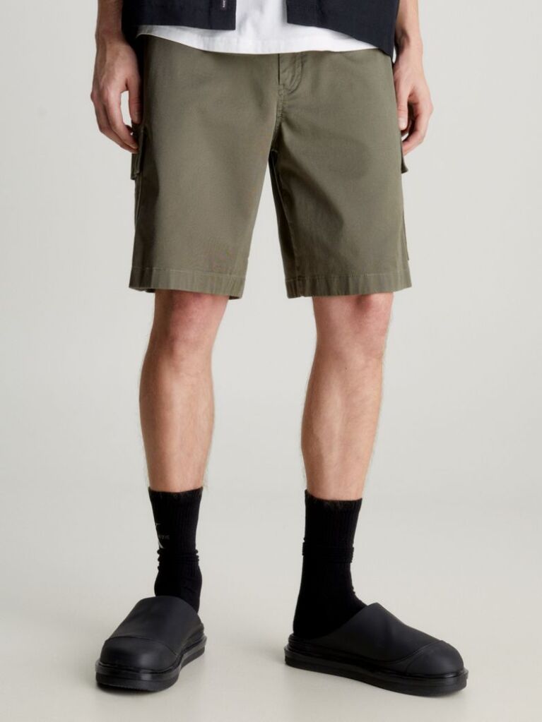 Green Calvin Klein Essentials. Timeless staples perfected for the modern wardrobe, evolving every season with new shapes and colours. These shorts are created with 20% recycled cotton, created by reprocessing existing materials.  Men