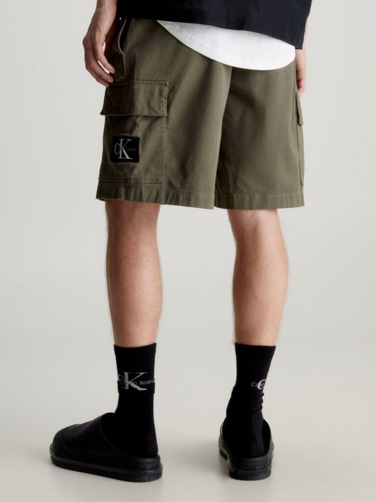 Green Calvin Klein Essentials. Timeless staples perfected for the modern wardrobe, evolving every season with new shapes and colours. These shorts are created with 20% recycled cotton, created by reprocessing existing materials.  Men