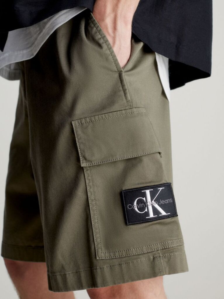 Green Calvin Klein Essentials. Timeless staples perfected for the modern wardrobe, evolving every season with new shapes and colours. These shorts are created with 20% recycled cotton, created by reprocessing existing materials.  Men