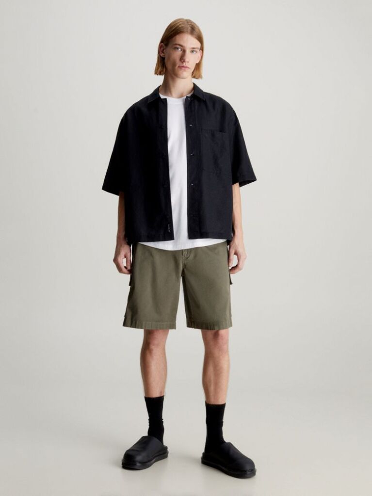 Green Calvin Klein Essentials. Timeless staples perfected for the modern wardrobe, evolving every season with new shapes and colours. These shorts are created with 20% recycled cotton, created by reprocessing existing materials.  Men