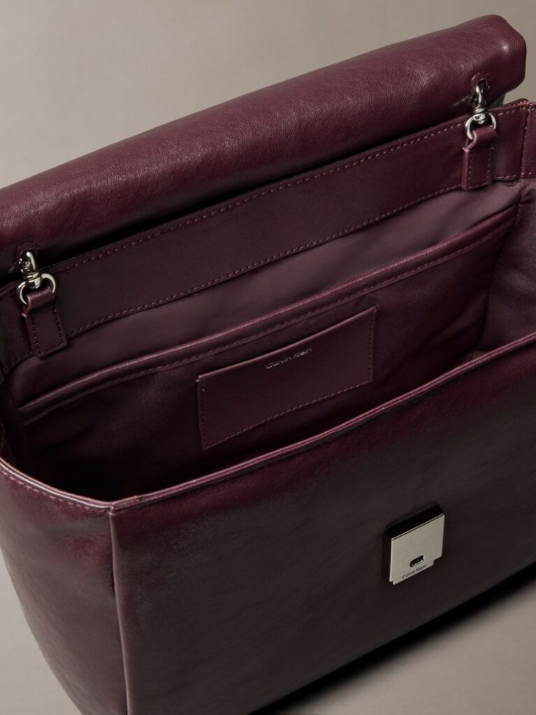 Red Defined by elegant, contemporary design, this collection features softly padded faux leather in elevated silhouettes. Finished with shiny Calvin Klein emblem hardware for a signature look  Women