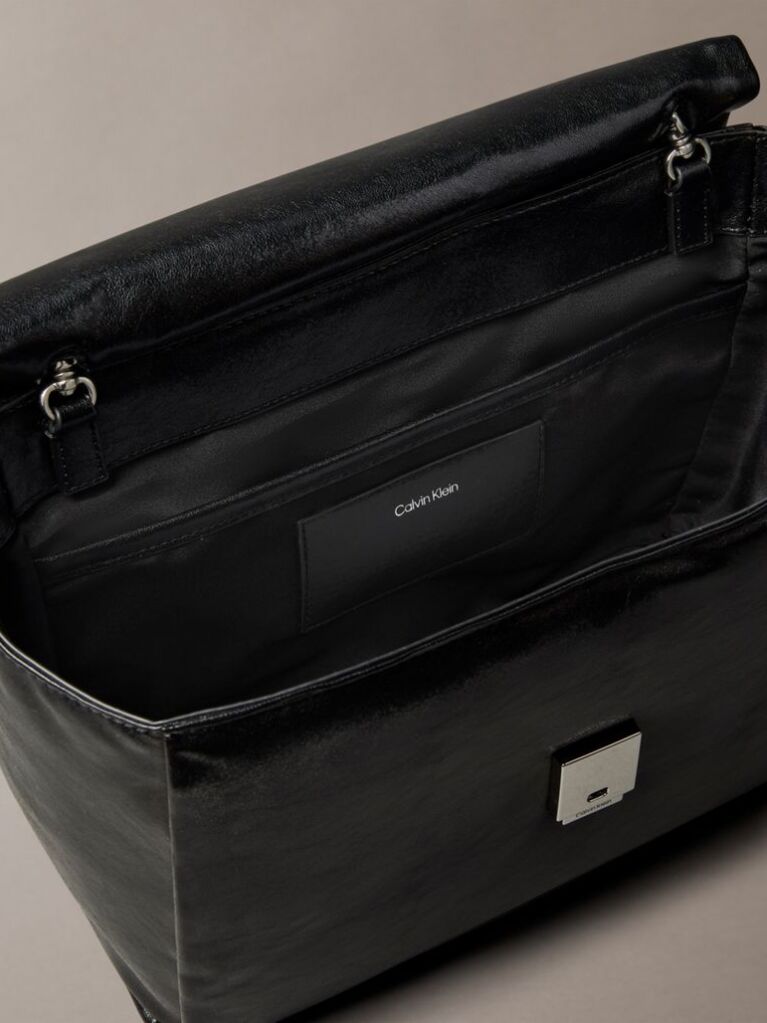 Black Defined by elegant, contemporary design, this collection features softly padded faux leather in elevated silhouettes. Finished with shiny Calvin Klein emblem hardware for a signature look  Women
