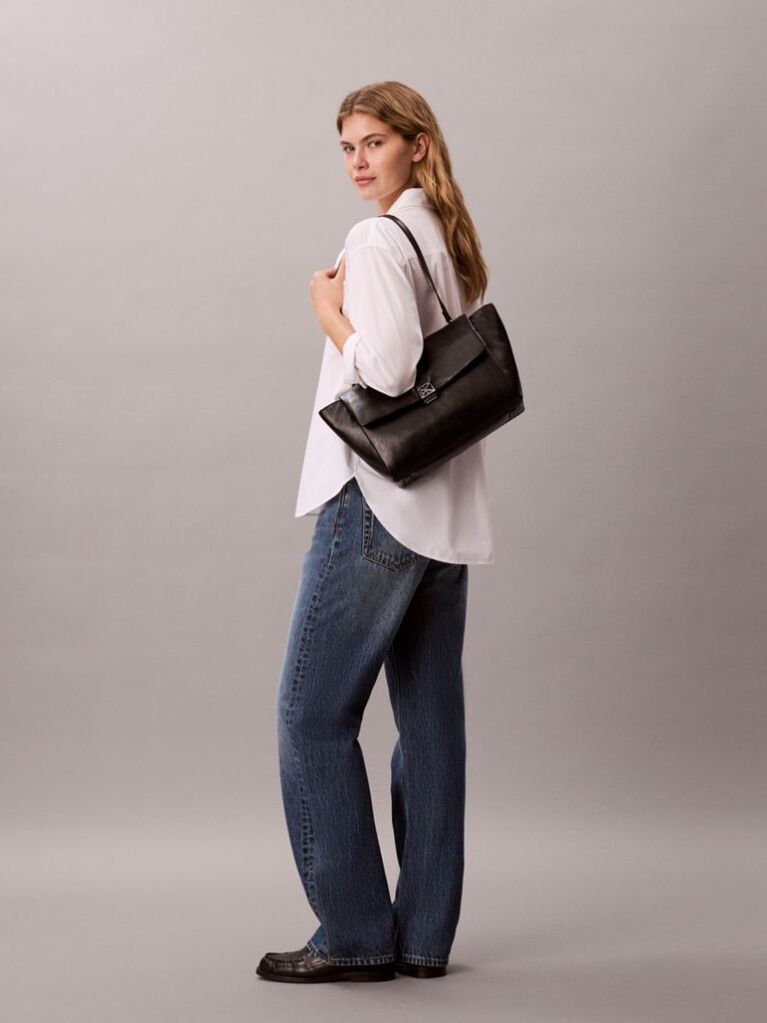 Black Defined by elegant, contemporary design, this collection features softly padded faux leather in elevated silhouettes. Finished with shiny Calvin Klein emblem hardware for a signature look  Women